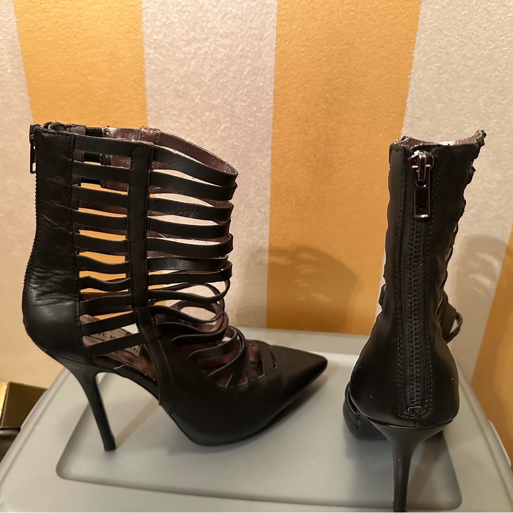 Black leather 4 inch heel with openings zips up back by Steve Madden.